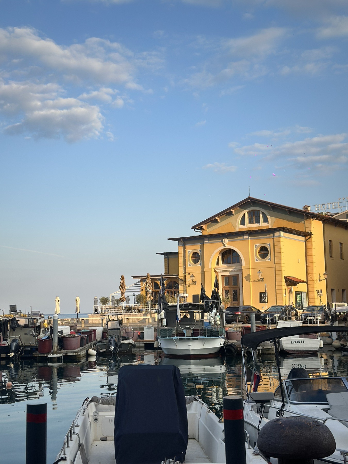 Piran harbour with boats and Venetian-style buildings at golden hour